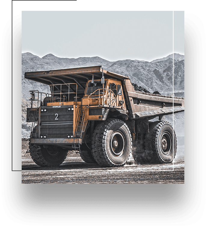 A large dump truck is parked on the side of a road.